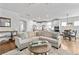 Open concept living room featuring neutral decor and an adjacent kitchen and dining area, perfect for entertaining at 460 Marston Pass, Acworth, GA 30102