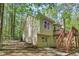 Angled view of the back of the home and yard featuring a wooden deck and a fenced yard at 191 Orchard Dr, Canton, GA 30115