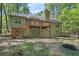 View of the back of the home with a wooden deck and stairs leading down to the yard at 191 Orchard Dr, Canton, GA 30115