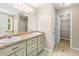 Bathroom with double sinks, large mirrors, walk in closet, and shower at 191 Orchard Dr, Canton, GA 30115