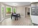Bright dining area with large windows offering views of the outdoor greenery and deck at 191 Orchard Dr, Canton, GA 30115