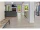 Open-concept living area with wood floors, stone fireplace, and seamless flow into a bright kitchen at 191 Orchard Dr, Canton, GA 30115