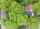 An aerial top-down view showing the property, large trees and landscaping and a deck and storage building at 2086 Harold Se Ave, Smyrna, GA 30080