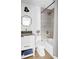 Charming bathroom with white cabinets, granite countertops, round mirror, and shower at 2086 Harold Se Ave, Smyrna, GA 30080