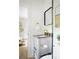 Modern half bath featuring gray vanity with brass fixtures, contemporary mirror, and stylish accents at 2086 Harold Se Ave, Smyrna, GA 30080