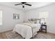 Cozy bedroom features hardwood floors, a neutral color palette, ceiling fan and a comfortable bed at 2086 Harold Se Ave, Smyrna, GA 30080