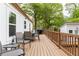 Spacious deck overlooking a wooded backyard with seating, table and BBQ grill at 2086 Harold Se Ave, Smyrna, GA 30080