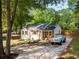 Quaint single story home with a well manicured lawn and driveway, shaded by mature trees at 2086 Harold Se Ave, Smyrna, GA 30080