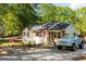 Beautiful one-story home featuring white siding, decorative shutters, and lush, green landscaping at 2086 Harold Se Ave, Smyrna, GA 30080