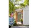 Exterior entrance of home with light green front door, wood pillars and American flag at 2086 Harold Se Ave, Smyrna, GA 30080