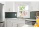 Renovated kitchen with stainless steel appliances, a window over the sink, and white cabinetry at 2086 Harold Se Ave, Smyrna, GA 30080