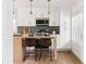 Modern kitchen with white cabinets, stainless steel appliances, a tiled backsplash and pendant lighting at 2086 Harold Se Ave, Smyrna, GA 30080