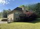 Exterior view of the home showcasing a well-kept lawn and deck at 4383 Post Rd, Winston, GA 30187