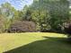 Large grassy backyard with lush trees creating a private outdoor space at 4383 Post Rd, Winston, GA 30187