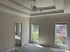Bedroom with a ceiling fan, two windows, and bathroom entrance, letting in natural light at 4383 Post Rd, Winston, GA 30187