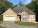 Charming single-story home with a stone accent, a two-car garage, and a welcoming curved driveway at 4383 Post Rd, Winston, GA 30187