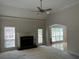 Living room featuring a fireplace, ceiling fan, and large windows at 4383 Post Rd, Winston, GA 30187