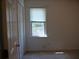 Cozy bedroom features a bright window and a closet with a door at 4909 Farm Valley Ne Dr, Woodstock, GA 30188