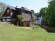 Back of home showing brick and brown siding, deck and backyard at 4909 Farm Valley Ne Dr, Woodstock, GA 30188