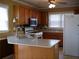Functional kitchen with light wood cabinets, appliances, and a breakfast bar at 4909 Farm Valley Ne Dr, Woodstock, GA 30188