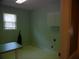 Functional laundry room with a table, window, and storage cabinet at 4909 Farm Valley Ne Dr, Woodstock, GA 30188