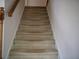 Carpeted stairway featuring wooden handrail leads to the next level of the home at 4909 Farm Valley Ne Dr, Woodstock, GA 30188