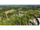 Wide aerial view showing the proximity of this home to woodlands, a meadow and the surrounding neighborhood at 9062 Selborne Ln, Palmetto, GA 30268