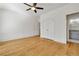 Bedroom featuring hardwood floors, ceiling fan, large closet, and bathroom at 9062 Selborne Ln, Palmetto, GA 30268