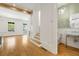 Open foyer area with views of staircase, half bath, and entryway to main living area with beam ceilings at 9062 Selborne Ln, Palmetto, GA 30268