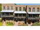 Brick townhouses with covered front porches, offering classic curb appeal at 9062 Selborne Ln, Palmetto, GA 30268