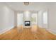Bright living room featuring a brick fireplace, hardwood floors and white trim throughout at 9062 Selborne Ln, Palmetto, GA 30268