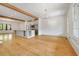 Open-concept living room and kitchen area with hardwood floors, beam ceilings, and lots of natural light at 9062 Selborne Ln, Palmetto, GA 30268