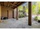 Spacious outdoor patio with fireplace, ceiling fan, brick walls, brick columns and stone floor at 9062 Selborne Ln, Palmetto, GA 30268