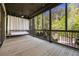 Screened porch with wood flooring, wood beam ceiling, outdoor fan, and a swing bed at 9062 Selborne Ln, Palmetto, GA 30268