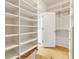 Walk-in closet with custom shelving and drawers for ample storage and organization at 9062 Selborne Ln, Palmetto, GA 30268