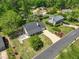 An aerial view of a home with well-manicured landscaping, a long driveway, and a backyard at 115 Braided Blanket Blf, Johns Creek, GA 30022