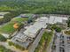 Aerial view showcasing the school and parking lot with athletic fields nearby including baseball and football fields at 115 Braided Blanket Blf, Johns Creek, GA 30022