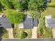Aerial view of home and yard featuring mature trees and landscaping at 115 Braided Blanket Blf, Johns Creek, GA 30022