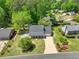 Aerial view of home and yard featuring mature trees and landscaping at 115 Braided Blanket Blf, Johns Creek, GA 30022