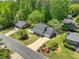 Aerial view of home and yard featuring mature trees and landscaping at 115 Braided Blanket Blf, Johns Creek, GA 30022