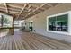 Expansive covered back porch with a swing, offering a serene outdoor space for relaxation at 115 Braided Blanket Blf, Johns Creek, GA 30022