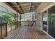Relaxing covered back porch with a swinging bench, and wooden ceiling with lots of space at 115 Braided Blanket Blf, Johns Creek, GA 30022