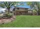 Spacious backyard with a covered patio and a lush green lawn, perfect for outdoor living at 115 Braided Blanket Blf, Johns Creek, GA 30022