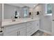 Bright bathroom featuring a large vanity with double sinks, neutral paint, and stylish faucets at 115 Braided Blanket Blf, Johns Creek, GA 30022