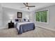 Comfortable bedroom featuring neutral decor, a ceiling fan, and a bright window view at 115 Braided Blanket Blf, Johns Creek, GA 30022