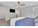 Bright bedroom with a ceiling fan and wall-mounted TV, with access to the walk-in closet at 115 Braided Blanket Blf, Johns Creek, GA 30022