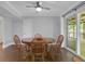 Bright dining room with wooded table and chairs, view to a deck, neutral walls and ceiling fan at 115 Braided Blanket Blf, Johns Creek, GA 30022