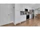 Modern kitchen with stainless appliances, white cabinets, granite counters, and tile backsplash at 115 Braided Blanket Blf, Johns Creek, GA 30022