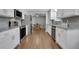 Updated kitchen featuring stainless steel appliances, granite countertops, view into the dining room at 115 Braided Blanket Blf, Johns Creek, GA 30022