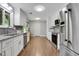 Modern kitchen with stainless steel appliances, granite countertops, and white cabinets at 115 Braided Blanket Blf, Johns Creek, GA 30022